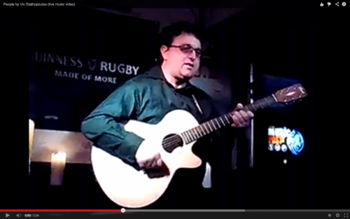 Vic Stathopoulos at the International Bar performing People with his guitar